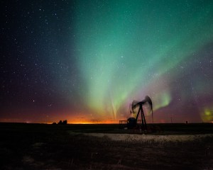 aurora borealis over a pumpjack
